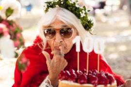 Woman eating cake at her 100th birthday