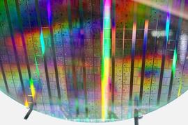 A close-up view of a shiny etched silicon wafer