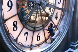 image of boy standing on diameter of large clock from Hugo movie
