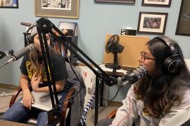 Two students wearing headphones and using recording equipment create a podcast in a recent Chicano Studies class.