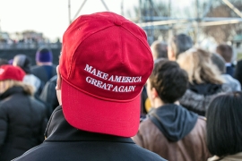 man wearing backward red Make America Great Again hat