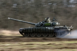 A Russian tank races across a field during training exercises in Russian lands adjacent to the Ukraine border