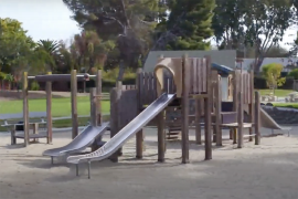 a computer rendering of an outside playground with slides and swings