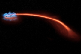 red-orange tail shows path of star pulled into a black hole