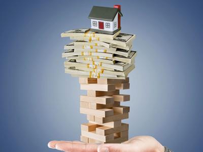 Graphic of a hand holding a house on top of a pile of a cash, both on top of a jenga set