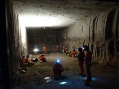 Many people standing in excavated cavern in Boulby mine