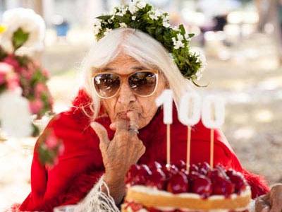 Woman eating cake at her 100th birthday