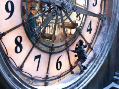image of boy standing on diameter of large clock from Hugo movie