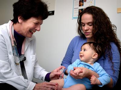 Doctor giving vaccine to child