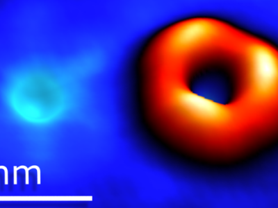 Scanning tunneling microscopy image of an oxygen atom substituting sulfur and a sulfur vacancy in tungsten disulfide.