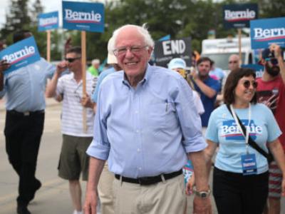 U.S. Sen. Bernie Sanders of Vermont at a Democratic presidential campaign event, surrounded by people carrying Bernie signs