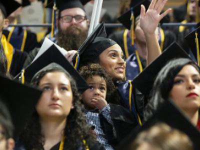 A Berkeley student who brought her son to the commencement ceremony symbolizes the value of university education across generations.