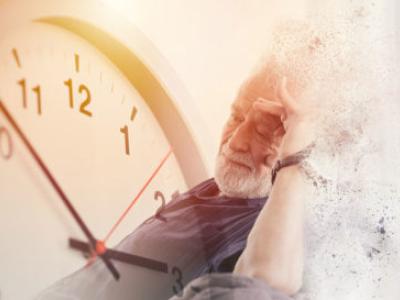  a stock image of an old man with Alzheimer's next to giant clock.