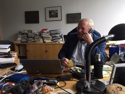 Reinhard Genzel on the phone in his office