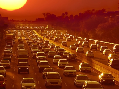 a California freeway traffic jam in ominous orange sunset light