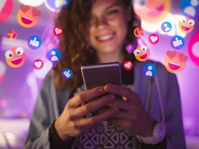 Young woman holding an electronic device with hearts and likes floating in the background.