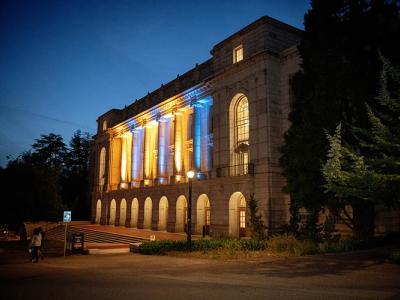 Wheeler Hall lit up in blue and gold