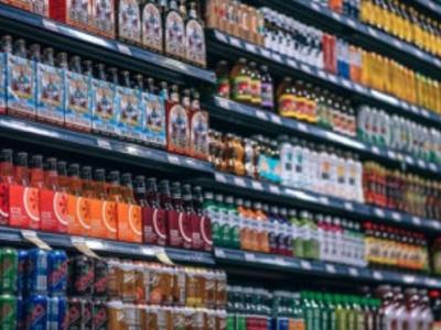 Rows of soft drinks in store aisle