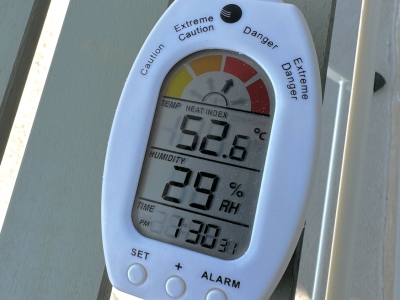 white plastic digital device showing temperature, humidity and heat index