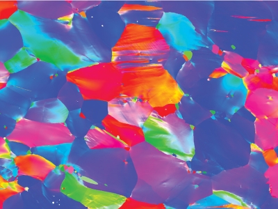 A field of pink, purple, cyan, indigo, orange, and yellow shapes packed together, resembling vibrant abstract art.