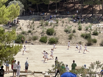 Spectators watch footraces at the 2024 Nemean Games on the slopes of the ancient stadium