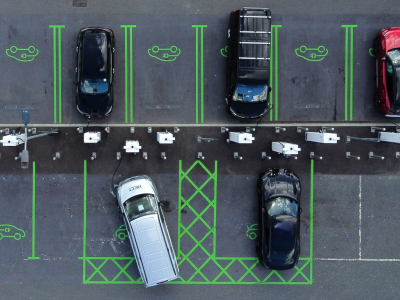 Birdseye view of electric vehicles charging in a parking lot.