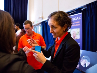 A person during an event for business startups at UC Berkeley demonstrates a dental implant that her company produces.