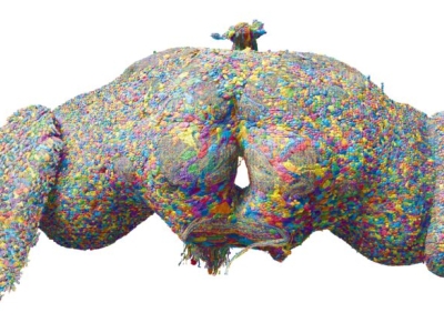 a symmetric, oblong object covered with tiny patches of gray and bubble-gum yellows, blues, oranges and reds