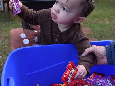 A toddler gets her hands on some candy at a Halloween event in Ashland, Ky. (Kevin Goldy/The Daily Independent via AP)