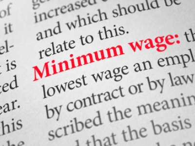 Newsprint with the word "Minimum wage" highlighted in red