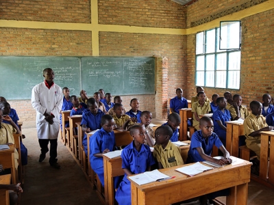 A teacher and his students in a classroom in Rwanda
