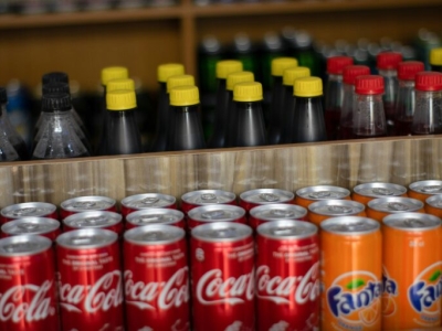 several rows of soda and other sugar-sweetened beverages on a shelf