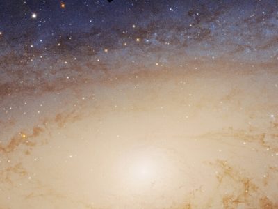a bright yellow spot amid stars, with a blue background of stars