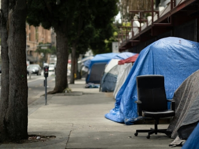 image of a couple of tented homes on the sidewalk