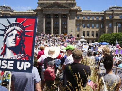 A sign with the Statue of Liberty that says "Rise Up"
