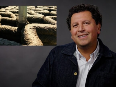 image of a man smiling with overlayed presentation slide to the left of him