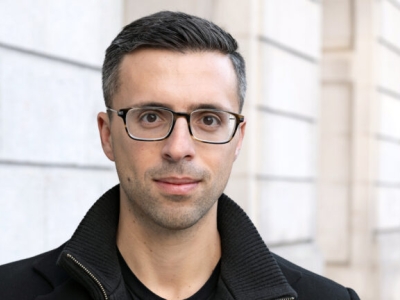 headshot of a man in glasses