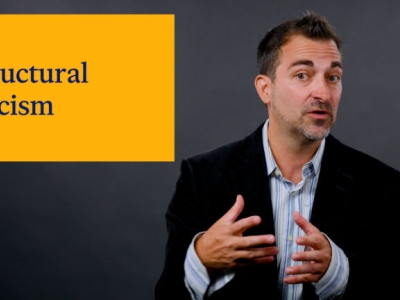 thumbnail of a man explaining structural racism with an overlayed presentation slide to his left
