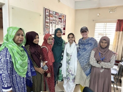 A group of seven people pose for a photo that was taken during Cara Schulte's research in Bangladesh