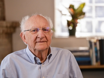 John Clarke sitting in his office