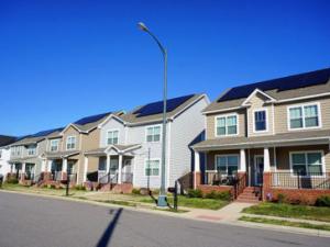 row of houses with solar panels on the roofs