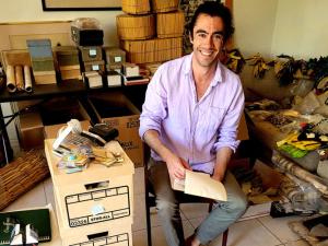 Zachary O'Hagan in the home of anthropologist Gerald Weiss packing up his Ashaninka collection.