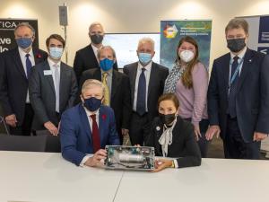 masked scientists and policymakers gathered around GHG sensor