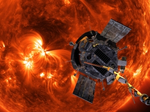 a satellite hovering over an angry red sun