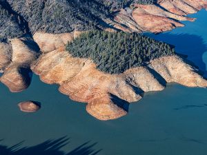 An aerial photo of Shasta Lake. The water level is low and the &quot;bathtub ring&quot; left by higher water levels is clearly visible.