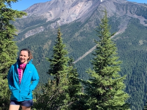 Penny Wieser standing with a Cascade mountain peak in background.