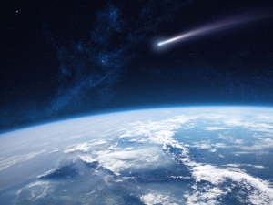 Image showing a view of planet Earth and a comet from space.