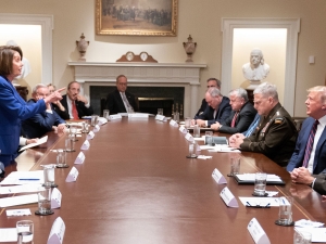 At a table in the White House dominated by men, House Speaker Nancy Pelosi lectures President Donald Trump