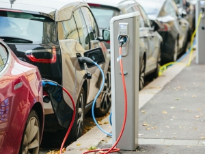 image of electric vehicles plugged in and charging on the street
