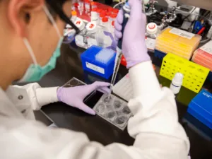 image of scientist pipetting in lab